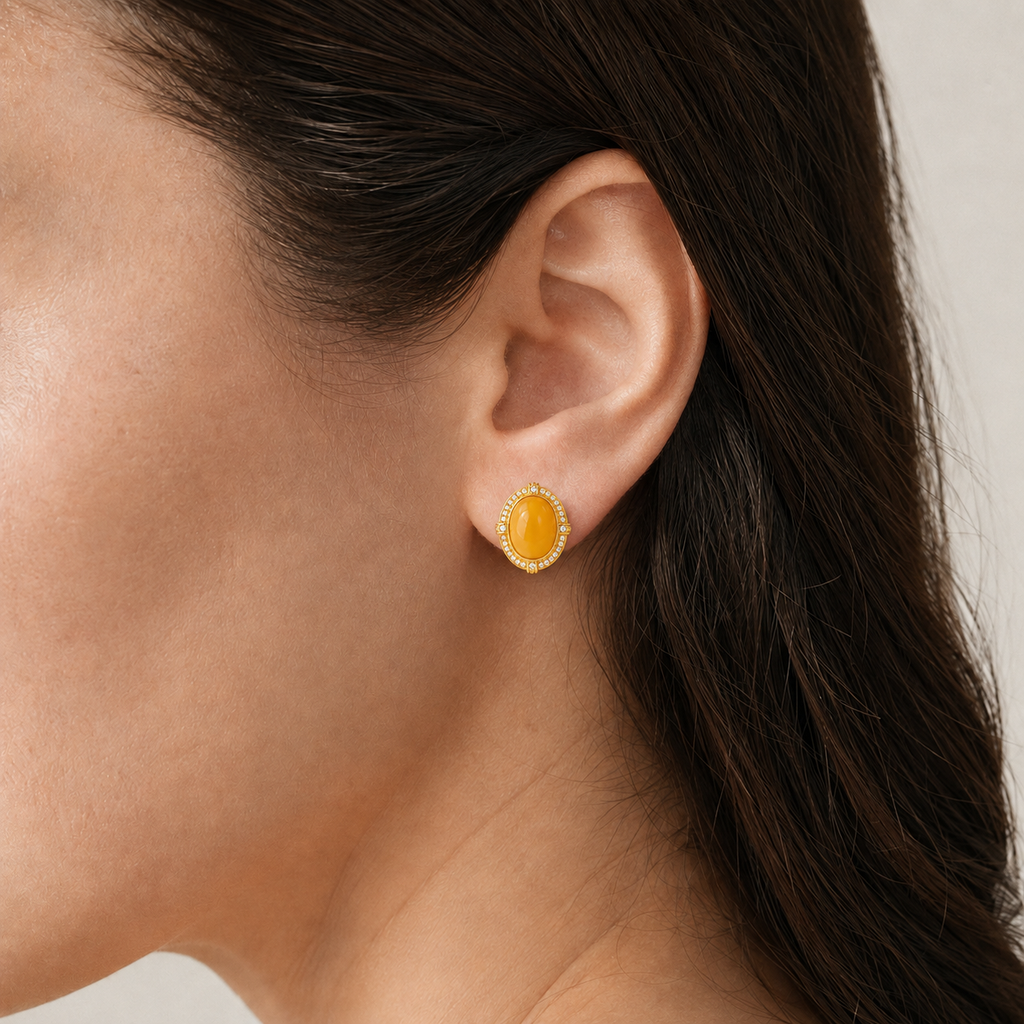 Natural amber stud earring worn on a model, side view
