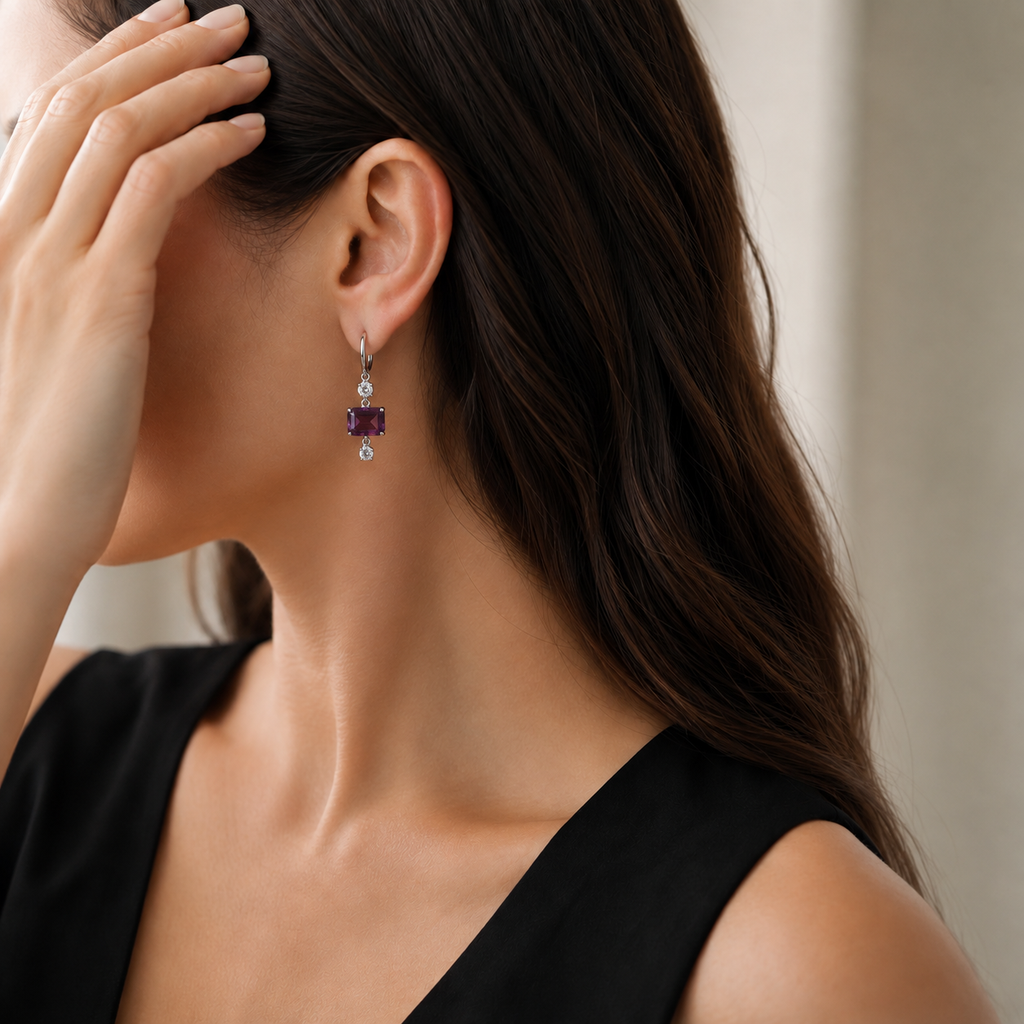 Natural amethyst drop hoop earring styled with a black dress on a model