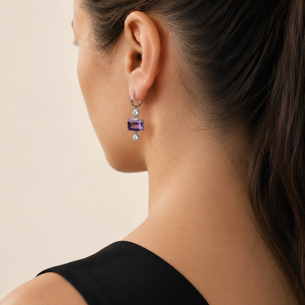 Natural amethyst drop hoop earring worn on a model, rear three-quarter view