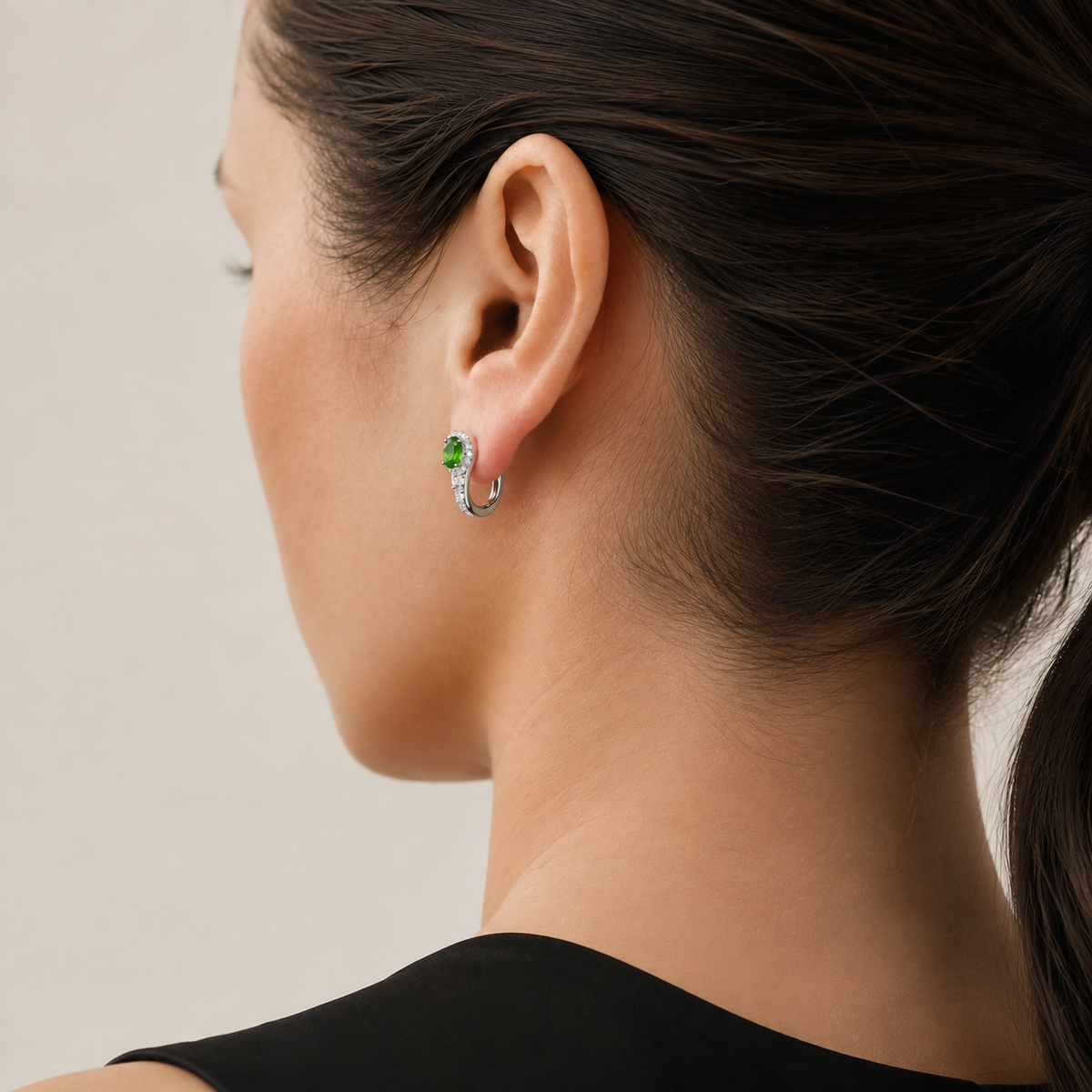 Natural chrome diopside hoop earring worn on a model, rear three-quarter view