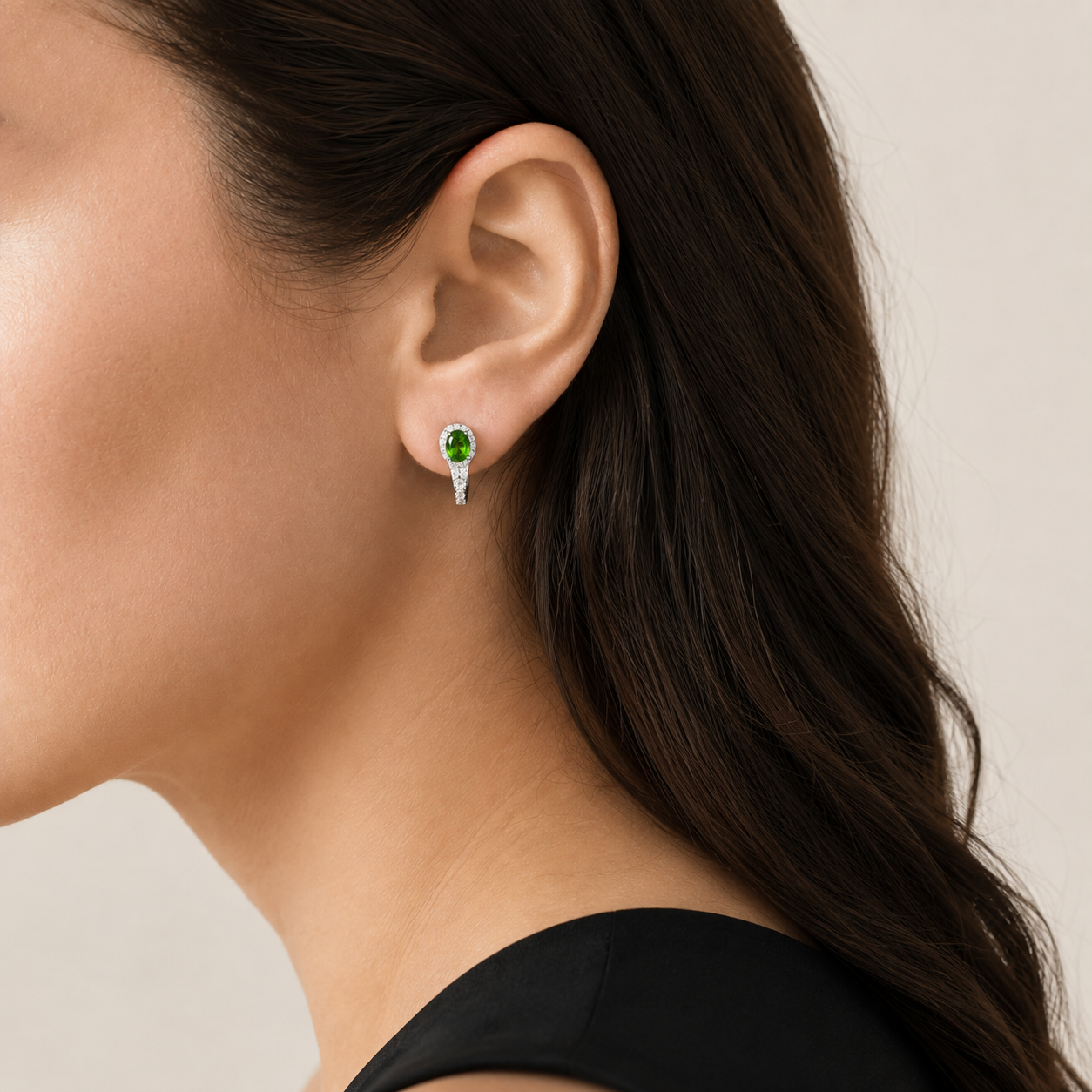 Natural chrome diopside hoop earring worn on a model, side view