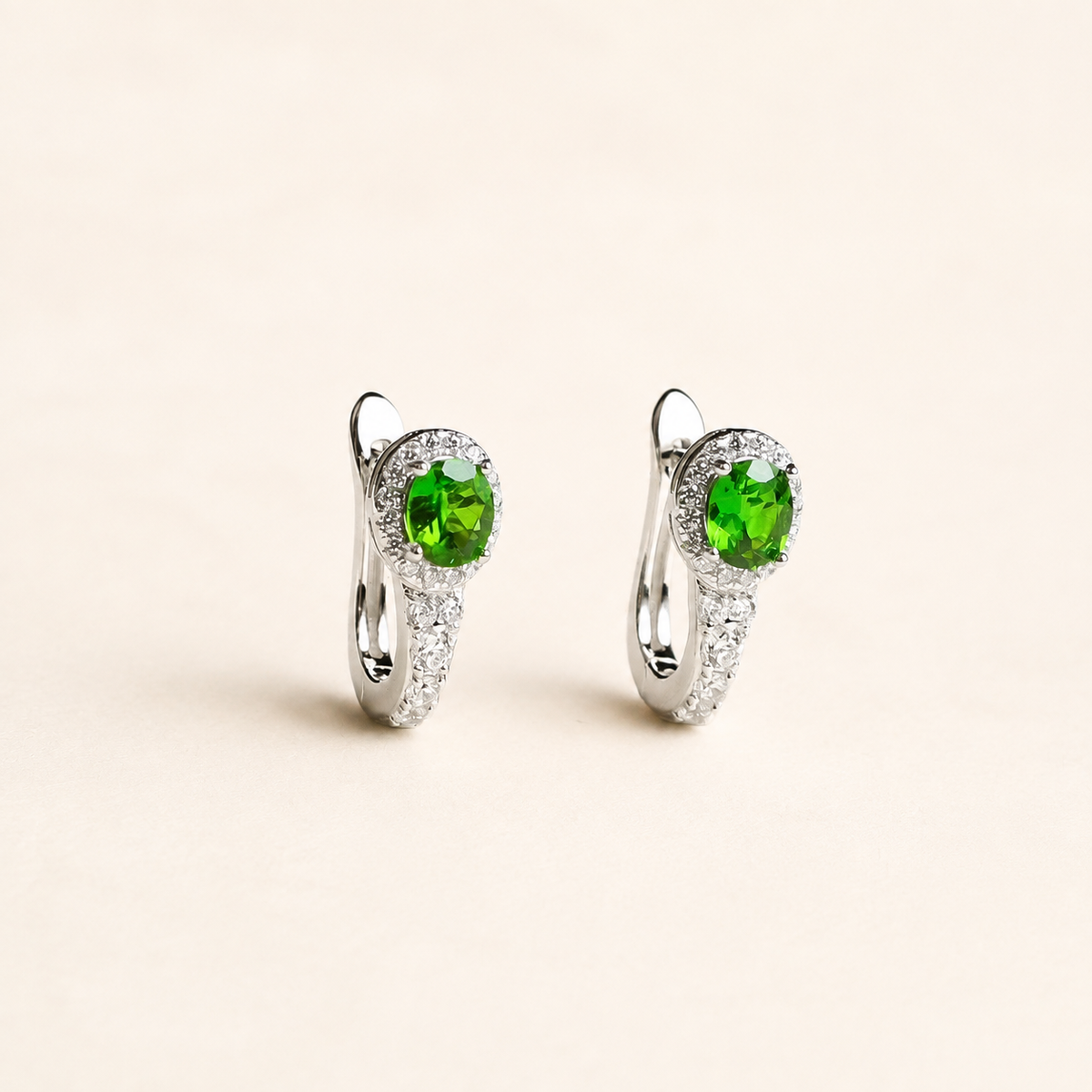 Natural chrome diopside hoop earrings on a warm ivory background