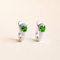 Natural chrome diopside huggie earrings on a warm ivory background