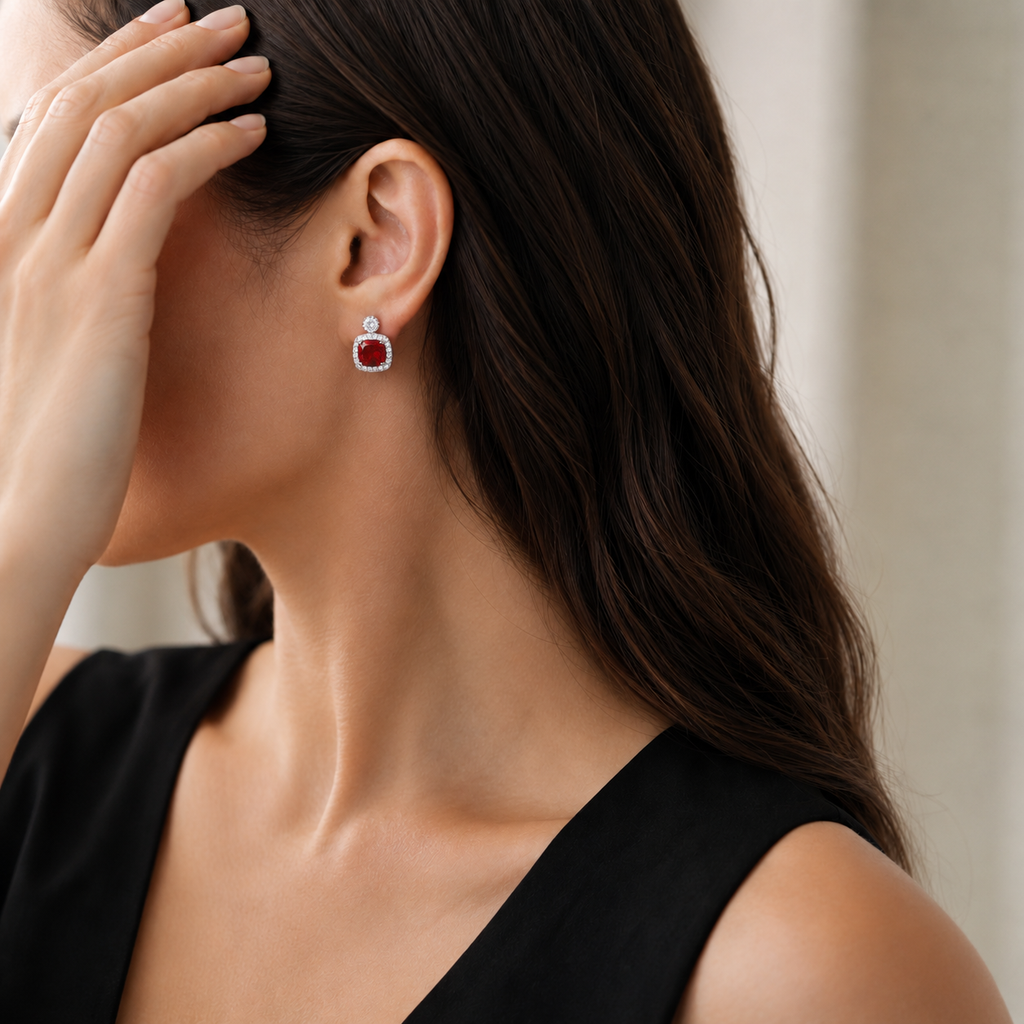 Natural garnet halo stud earring styled with a black dress on a model