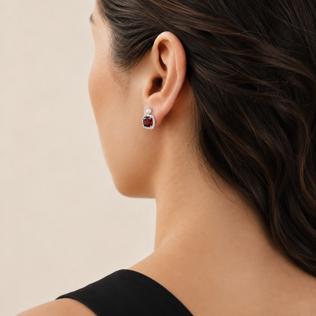 Natural garnet halo stud earring worn on a model, rear three-quarter view