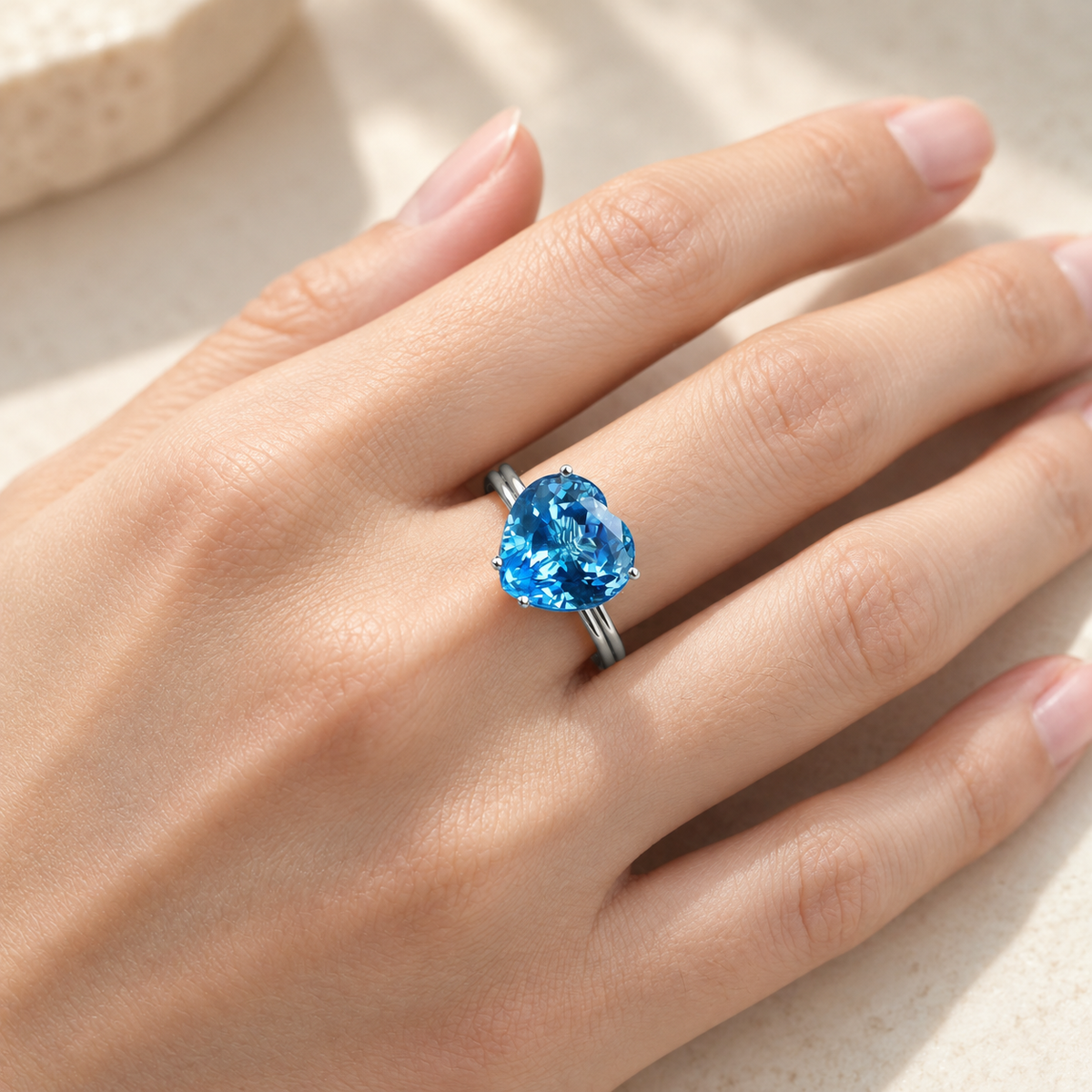 Natural Swiss blue topaz heart ring worn on hand