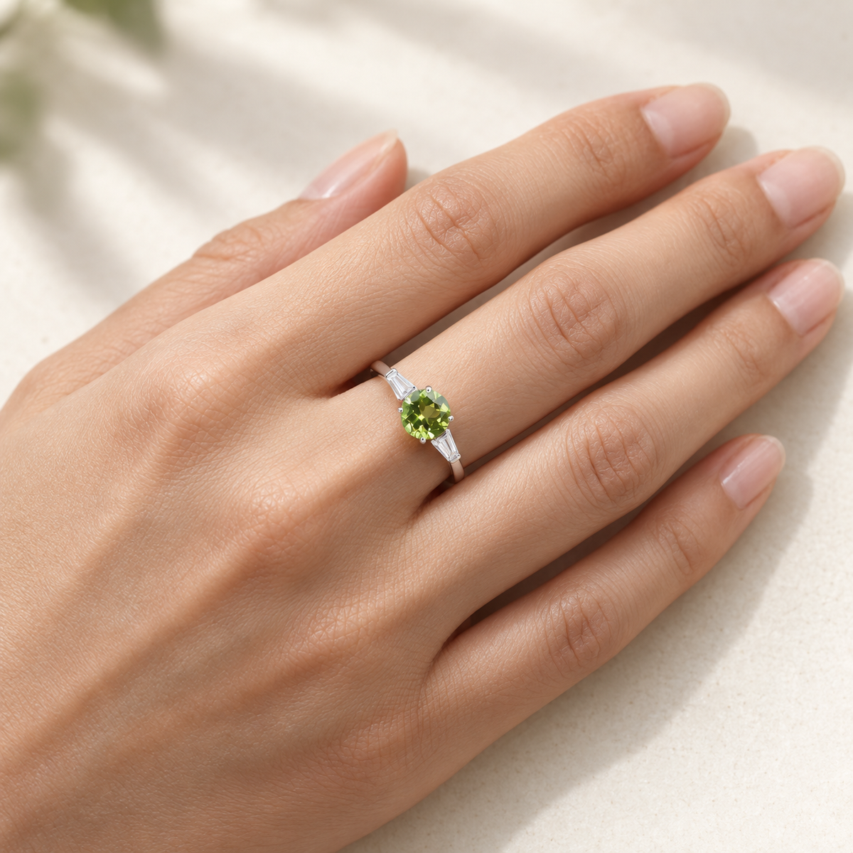 Natural peridot three stone ring worn on hand
