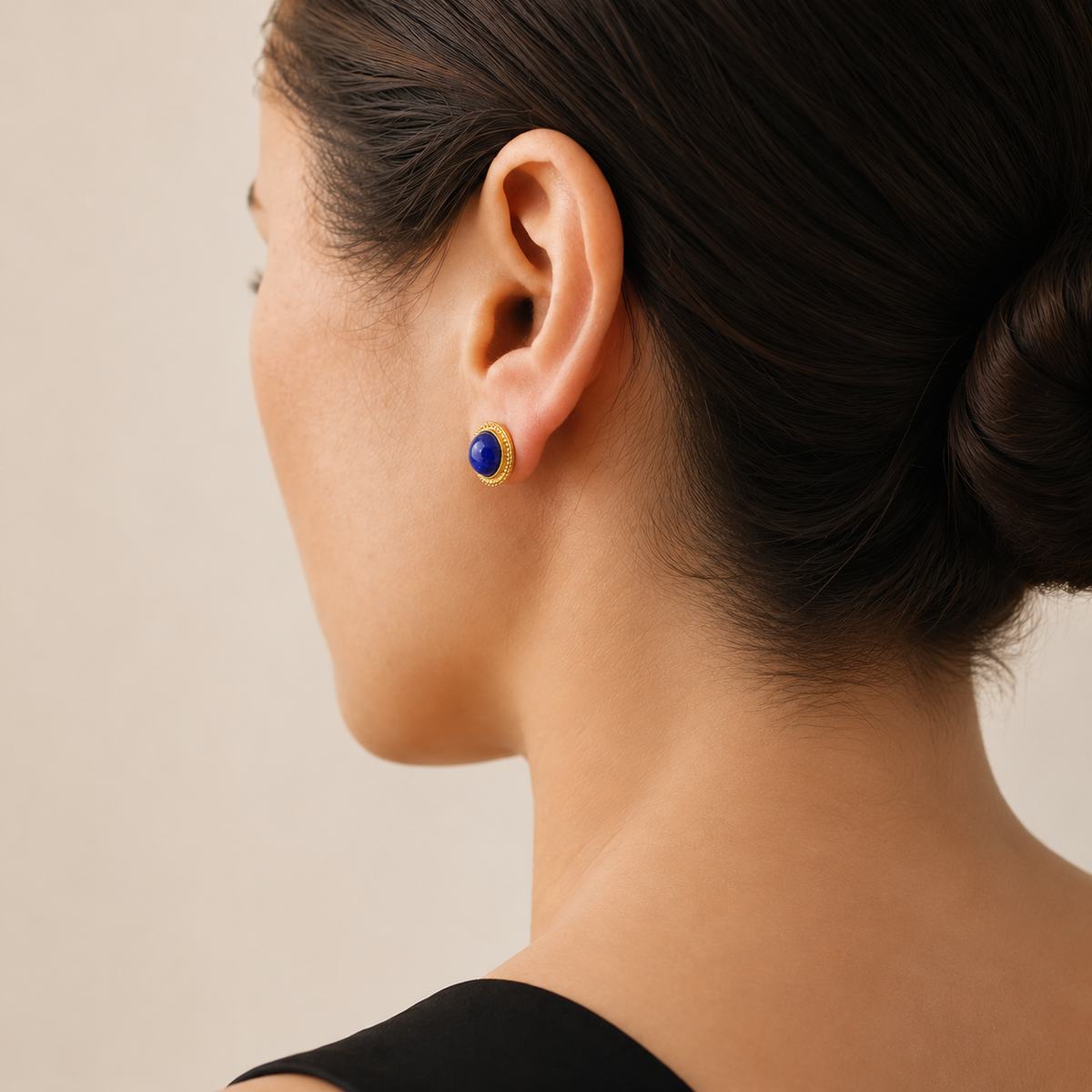 Natural lapis lazuli stud earring worn on a model, rear three-quarter view