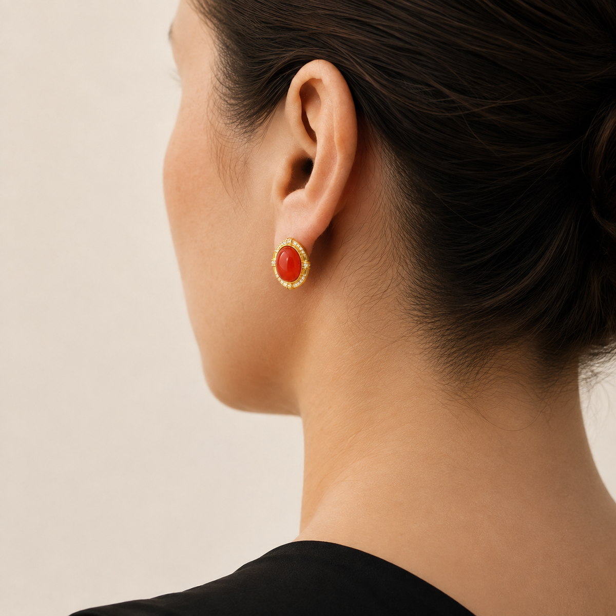 Natural Nanhong red agate stud earring worn on a model, rear three-quarter view