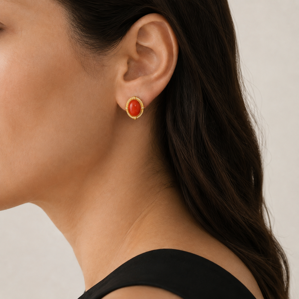Natural Nanhong red agate stud earring worn on a model, side view