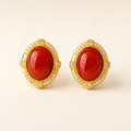 Natural Nanhong red agate stud earrings on a warm ivory background