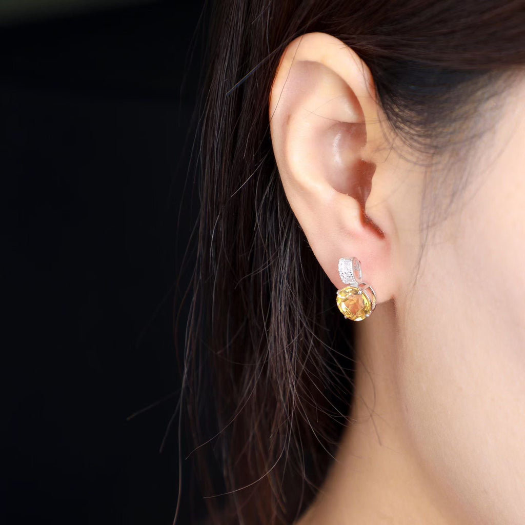 Natural Brazilian citrine round drop earrings worn on ear