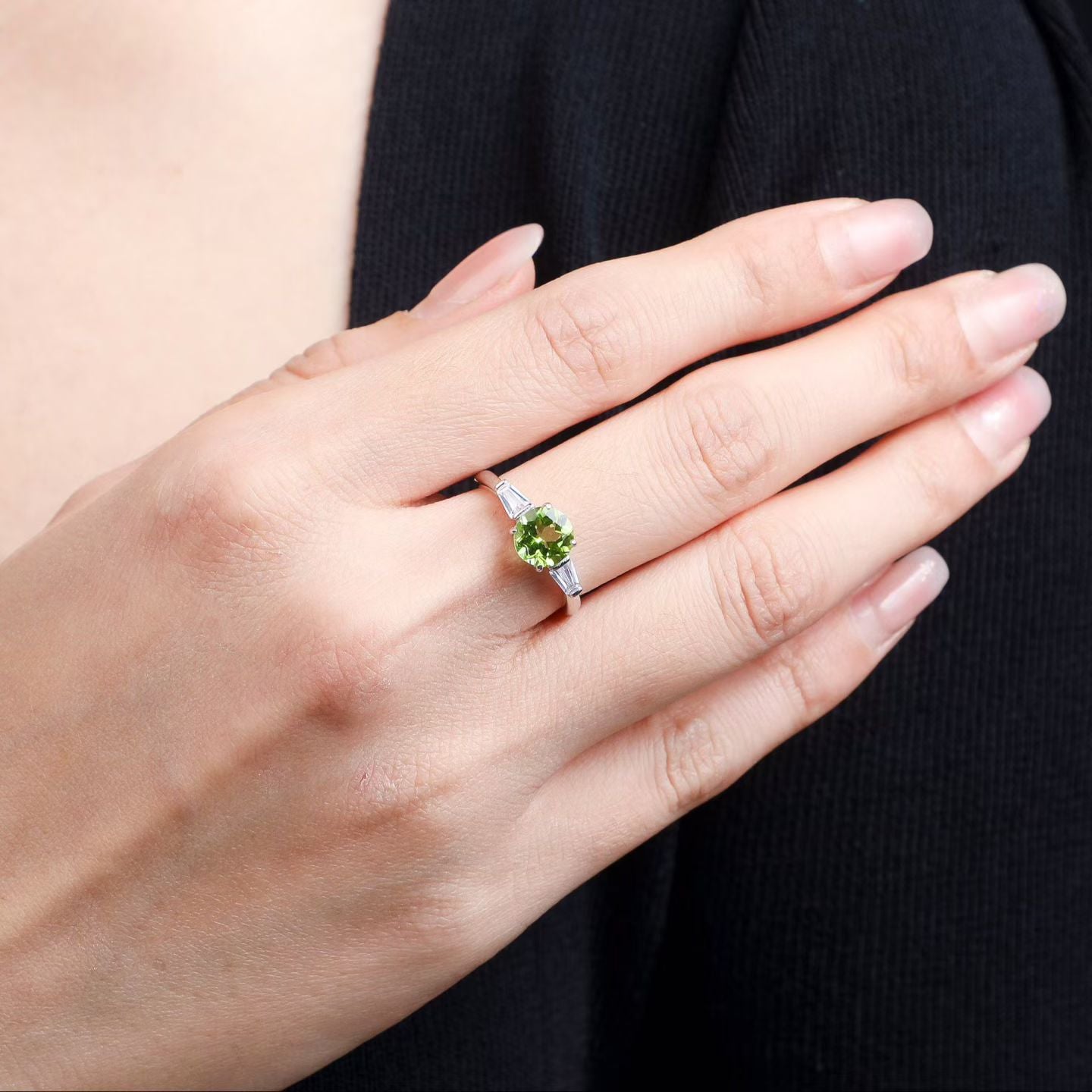 Natural peridot three-stone ring in 925 sterling silver worn on hand