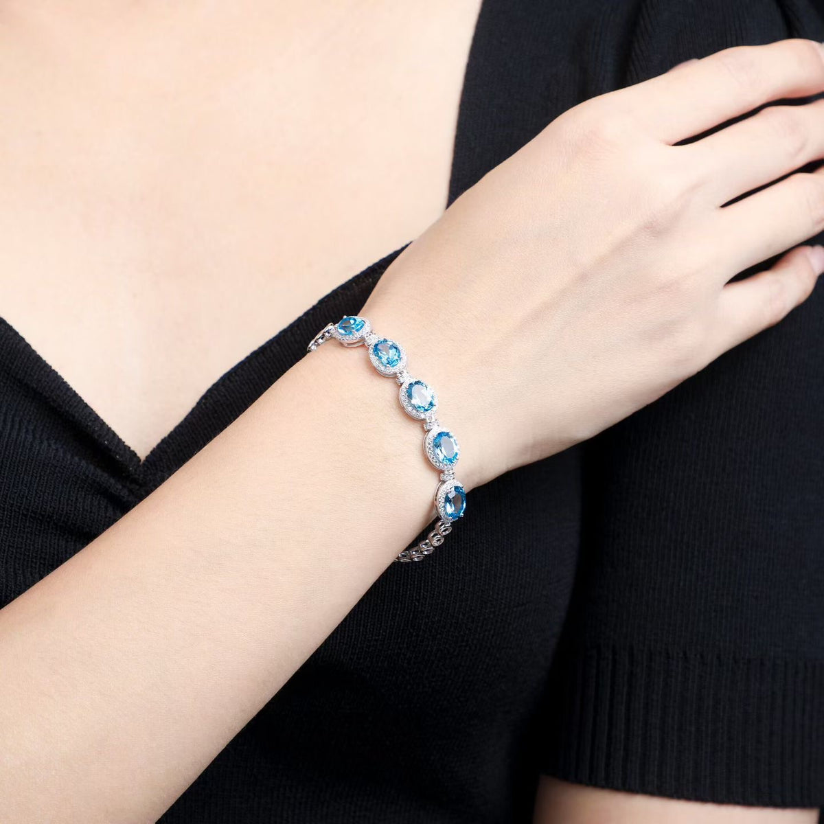 Natural Swiss blue topaz sterling silver bracelet worn on wrist