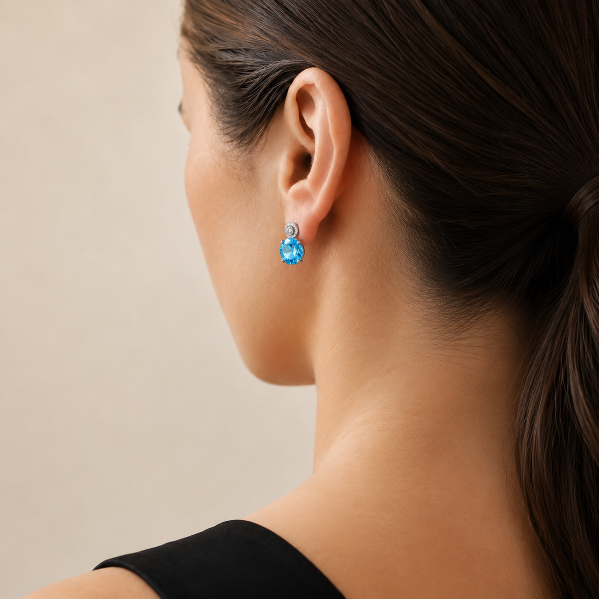 Natural Swiss blue topaz stud earring worn on a model, rear three-quarter view