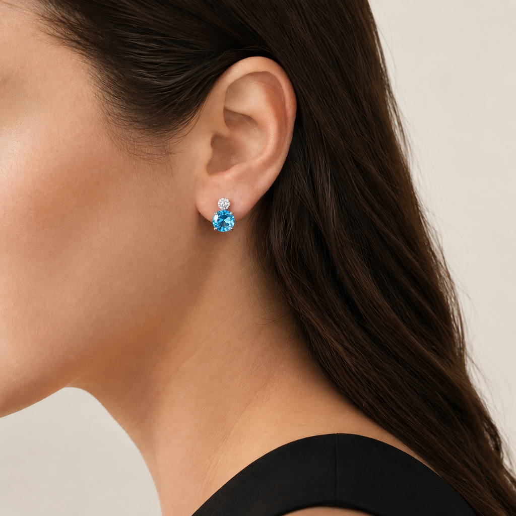 Natural Swiss blue topaz stud earring worn on a model, side view