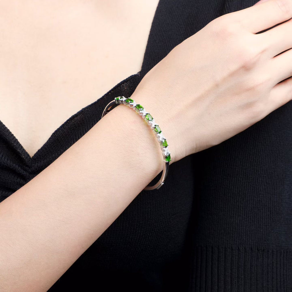 Model wearing natural chrome diopside bangle bracelet